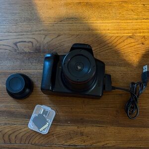 Black Compact Digital Camera with Lens Cap and SD Card
